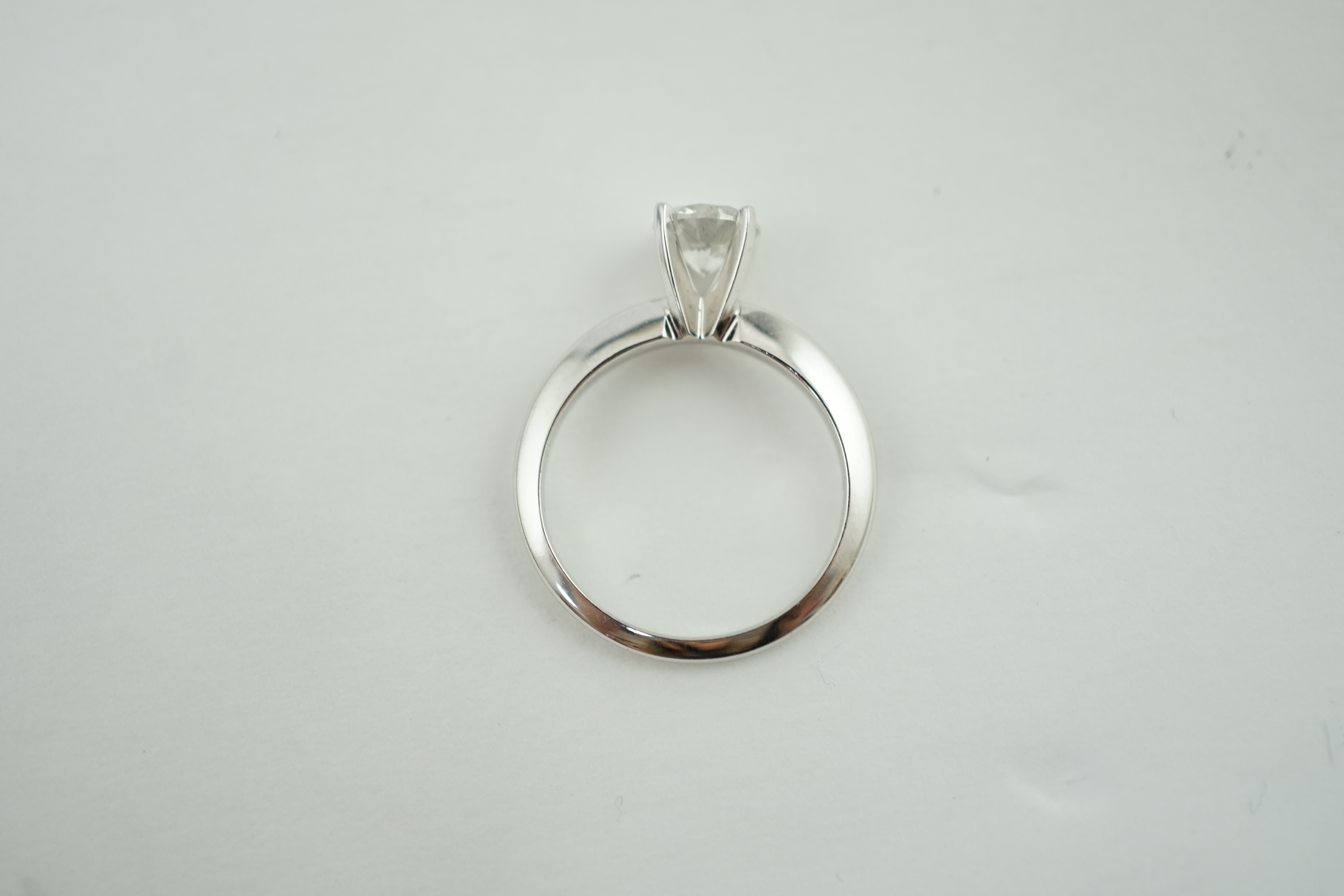 A modern 14k gold and solitaire diamond set ring